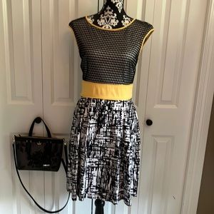 Classy black and white dress with full skirt & yellow piping and band at waist.